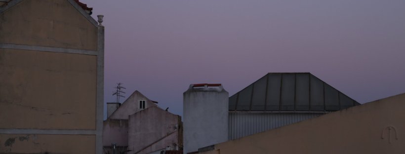 sunset above houses in lisbon, portugal